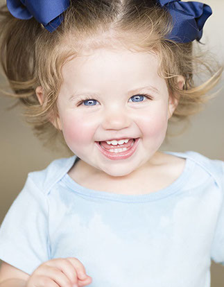 Toddler girl with pig tails and ribbons