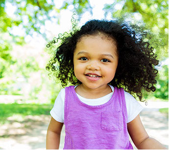Girl toddler outside with purple dress